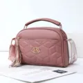 Stylish pink quilted crossbody bag with top handle, elegant tassel and comfortable shoulder strap. - Oak Red