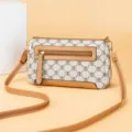 Vintage monogram cross-body shoulder bag with brown leather trim and metal hardware details. - White Letters