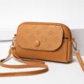 Brown PU leather mini crossbody bag with debossed floral pattern and gold tone hardware for women. - Earthy Yellow