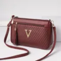 Wine red women crossbody shoulder bag with chevron texture and metal V logo charm. - Jujube Red