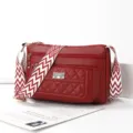 Red quilted crossbody bag for women with wide geometric strap and multiple zipper pockets. - Jujube Red