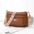 Stylish brown leather shoulder bag with wide geometric strap and multiple zipper pockets. - Yellow Brown