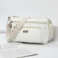White multi-zipper crossbody shoulder bag featuring quilted pocket and chic patterned strap. - Off White