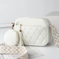 White quilted crossbody bag with heart embroidery, small round coin purse, and wide strap. - White