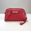 Red leather women's mini crossbody shoulder bag with metal bow and chic chevron stitched design. - Jujube Red