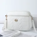 White quilted crossbody bag with stylish tassel and gold hardware for daily casual wear. - Off White