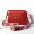 Red quilted women shoulder bag with wide strap and chic metallic branding details. - Jujube Red