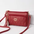Red leather crossbody bag with tassel and double heart emblem, stylish women messenger bag. - Jujube Red