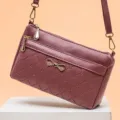 Vintage purple crossbody shoulder bag with chic bow accent, textured leather and gold hardware. - Oak Red