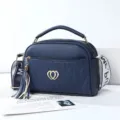 Stylish dark blue leather shoulder bag with chic heart logo and tassel charm for women. - Deep Blue - Double Heart