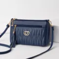 Elegant dark blue leather crossbody bag for women with chic quilted pattern, tassel and gold hearts. - Dark Blue