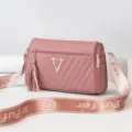 Pink cylindrical shoulder bag with metal V logo and letter strap for stylish wear. - Oak Red