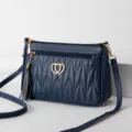 Dark blue quilted crossbody shoulder bag for women with gold heart hardware and stylish tassel. - Dark Blue