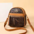 Women's brown monogram vertical cross-body mobile phone bag with heart clasp and zipper pockets. - Letter Print