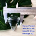 K9 glass crystal diamond pendant detail view showing precision size measurement with caliper tool. - 50x40mm