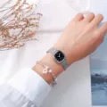 Minimalistische quadratische Damenuhr mit Mesh Armband und schickem Trockenblumen Armband. - Milanaise-Armband mit schwarzem Zifferblatt