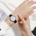 Minimalist quartz watch with black leather strap and white dial variant for daily wear. - Women's Black Strap White Dial