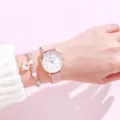 Close-up of a cute pink leather strap watch with a white dial and beaded charm bracelet. - Pink