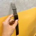 Detail view of the black silicone watch strap and metallic electronic display case design. - Black