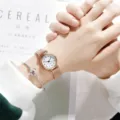 Detailaufnahme der minimalistischen Roségold Mesh Uhr mit weißem Zifferblatt und Armband. - Roségold-Armband Zahlen weißes Zifferblatt