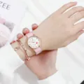 Detailed close-up of girls pink nylon strap quartz watch with matching rose gold Roman bangle. - Pink