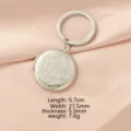 Stainless steel locket keychain with floral embossed design, practical photo pendant. - Round Patterned Locket / Steel