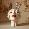 Detail view of the unique face shaped makeup brush holder, aesthetic boho desktop organizer. - Style A / Off White