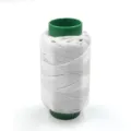 White household sewing thread spool with green core, perfect for daily hand and machine repair work. - White