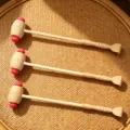 Wooden back scratcher detail view, showing dual massage head and natural texture on woven surface. - Default