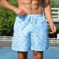 Close-up detail of men's blue beach shorts featuring a playful ice cream print and white drawstring. - S / Ice Pop
