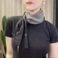 Two-tone silk scarf with tassel pendant, elegant neckwear detail for stylish everyday wear. - One Size / Black and Gray