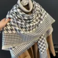 Houndstooth winter sjaal detail, warme cashmere-look textuur, elegante gedrapeerde accessoire. - Grijze houndstooth