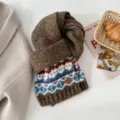 Cozy winter knitted scarf featuring a vintage Fair Isle jacquard pattern in rich brown tones. - Brown