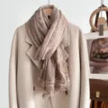 Detailed view of the elegant beige scarf with exquisite lace trim, perfect for autumn styling. - Light Coffee