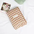 Detailed shot of brown and white houndstooth scarf with soft fringe and warm cashmere feel. - Coffee