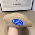 Knit beret hat detail view, classic beige casual painter hat with blue logo patch, fall style. - One Size / Apricot