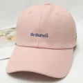 Pink cotton baseball cap with blue embroidered detail, classic curved brim and breathable eyelets. - Adjustable / Pink