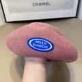 Knit beret close-up, pink colorway with blue oval logo patch, soft textured knit fabric. - One Size / Pink