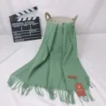 Green cashmere blend fringe scarf detail view, soft texture warm winter neck accessory. - Avocado Green