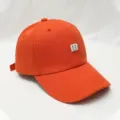 Orange baseball cap for women and men with stylish white m embroidery and curved brim. - Adjustable / Brick Red