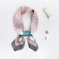 Detailed view of a stylish pink and grey geometric patterned silk scarf with chic design. - Grey-Trimmed Color-Block