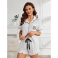 White short sleeve pajama set with black piping, pocket print and ruffled shorts detail. - TR88-White