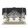 Elegant beaded evening clutch bag detail showing intricate crystal floral embroidery. - White