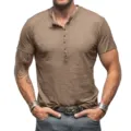Close up detail of men's casual muscle fit Henley short sleeve t-shirt with front button placket. - Khaki