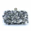 Detailed view of the silver sequin evening clutch, featuring exquisite floral bead embellishments. - Silver