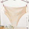 Close-up detail of champagne seamless women ice silk panties hanging on hanger nicely. - M / Champagne