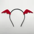 Close-up of black headband with red bat wings detail, Halloween costume accessory. - Red Bat Wing Headbands