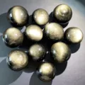 Detailed view of polished natural golden obsidian spheres showcasing unique sheen and texture. - Gold Obsidian Ball / Diameter 4.5-5cm
