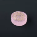Detailed close-up of natural rose quartz crystal disc with gold laser engraved lotus pattern. - Lotus Pattern