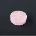 Close-up of rose quartz disc with laser engraved gold moon star patterns, crystal decor detail. - Star & Moon Pattern